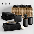 Black Bathroom Essentials Including Towels Woven Basket Soap Dish And Lotion Bottle