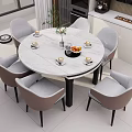 Round Marble Dining Table with Grey Chairs and Decorative Vase Fruit Cups in Modern Kitchen