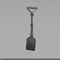 Decorative Metal Shovel With Green Red Accents And Ornate Handle Design