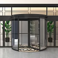 Modern Revolving Door Entrance With Black Frame Glass Green Plants And Patterned Floor
