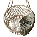 Natural Wicker Hanging Chair With Tassel Trim And Soft Green Blanket Accent