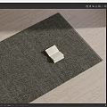 Square Rug Dark Gray Textured Design On Light Wood Floor With Book