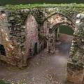 Ancient Stone Ruins Featuring Arched Doorway And Moss Covered Historical Walls