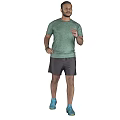 A Man Exercising Wearing Green T-Shirt Gray Shorts And Blue Sneakers On Gray Background