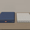 Blue And White Mattresses With Diamond Patterns On Wooden Floor In Simple Room