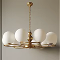 Elegant Modern Chandelier With Golden Hanging Chain And White Spherical Lampshades