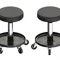 Two Black Bar Stools with Round Seats and Metal Bases on Wheels