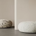 Round Padded Stools With Textured Surface And Dark Patterns In Minimalist Indoor Setting 3d model