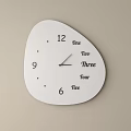 Irregular Shaped White Clock With Dial Featuring Numbers And English Words On Beige Wall