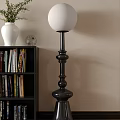Modern Black Floor Lamp With White Shade Next To Bookshelf Vase And Books