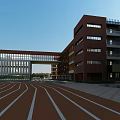 Modern Campus School Building With Multi Story Structure Green Playground And Lush Trees