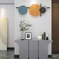 Orange Geometric Design Wall Clock With Grey Cabinet Green Plant Photo Frame And Decorative Items