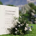 Outdoor Wedding Floral Display with White Blue Blooms Green Foliage and Welcome Sign