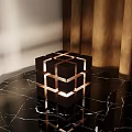 Modern Cube Table Lamp With Warm Lighting On Black Marble Tabletop And Metal Accents