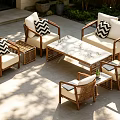 Patio Wicker Sofa With White Cushions Black White Checkered Pillows And Marble Top Coffee Table
