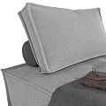 Gray Upholstered Single Sofa With Cozy Blanket And Stacked Books Design