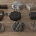 Various Stylish Cushions and Ottomans with Different Shapes Textures and Neutral Colors on Wooden Floor