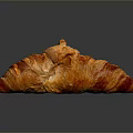 Golden Flaky Freshly Baked Croissant With Crispy Layers On Dark Reflective Surface