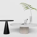 Modern Round Coffee Table With White Top Striped Base Decorative Plant Figurine And Book