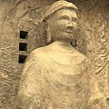 Ancient Garden Landscape Featuring Stone Buddha Statue And Carved Reliefs