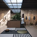 Modern Clothing Store Interior Featuring Glass Skylight Hanging Clothes Indoor Plants And Comfortable Seating