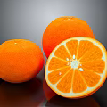 Three fresh oranges with one sliced showing juicy pulp and seeds on dark background