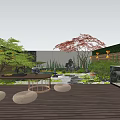 Courtyard Garden Design With Wooden Deck Round Table Woven Cushions Green Plants Red Maple Tree Stone Features And Stepping Path
