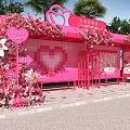 Pink Heart Shaped Outdoor Booth Decorated With Flowers Heart Cup Sign And Green Plants
