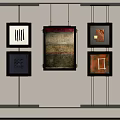 Framed Decorative Paintings With Various Designs And Colors Hanging On Wall