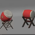 Traditional Red Musical Drums With White Drumheads Silver Decorations Golden Emblem And Black Wooden Stands