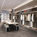 Fashionable Modern Clothing Store Interior Featuring Hanging Apparel Display Racks And Lights