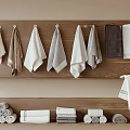 Soft Absorbent Cotton Towels Hanging on Wooden Rack and Stacked in Bathroom with Neutral Tones