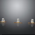 Three Transparent Boat Models With Orange Bases And Small Creature Figures On Gray Background With Reflection