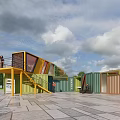 Colorful Container Buildings With Staircase And Service Kiosk In Outdoor Plaza
