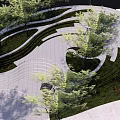 Serene Garden Landscape Design With Curved Walkways Trees Grass And Paved Stones