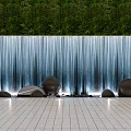 Stunning Waterfall Water Wall With Lush Green Backdrop Decorative Smooth Stones And Lighted Tiled Floor