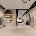 Clothing Store Exterior with Arched Entrance Window Display Mannequins White Building Street and Green Trees
