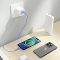 Phone Charging With Power Bank Cable And Another Phone On Wooden Desk