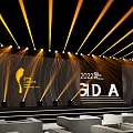 2022 BIDA Event Stage With Yellow Light Beams Trophy Logo Background And Seats