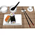 Sushi Rolls On White Plate With Bamboo Mat Chopsticks And Small Bowls