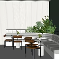 Modern Lounge Area Featuring White Curved Sofa Orange Chairs Round Tables and Green Plant Wall