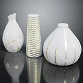 Modern White Vases With Gold Details And Various Textured Patterns On Reflective Surface 3d model