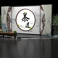 Traditional Tea Ceremony Setting With Circular Calligraphy Backdrop Bamboo Rockery And Wooden Table