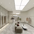 Modern Clothing Store Interior With Clothing Racks Sofa Seating Potted Plants And Marble Flooring