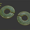 Two Green Notched Circular Artifacts With Blue Green Surface Patterns