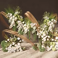 Elegant Floral Arrangement With Golden Curved Decorations And White Green Flowers