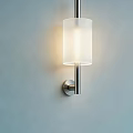 Modern Wall Lamp With White Cylindrical Lampshade And Silver Bracket On Light Blue Wall