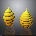 Two Yellow Spiral Stacked Sculptures With Reflective Bases On Dark Surface