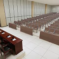 Spacious Conference Room With Rows of Chairs Front Desk and Windows