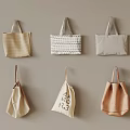 Different Styles of Stylish Fabric Tote Bags in Various Colors Hanging on Wall